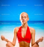 depositphotos_6306836-Woman-doing-yoga-moves-or-meditating-on-beach.jpg